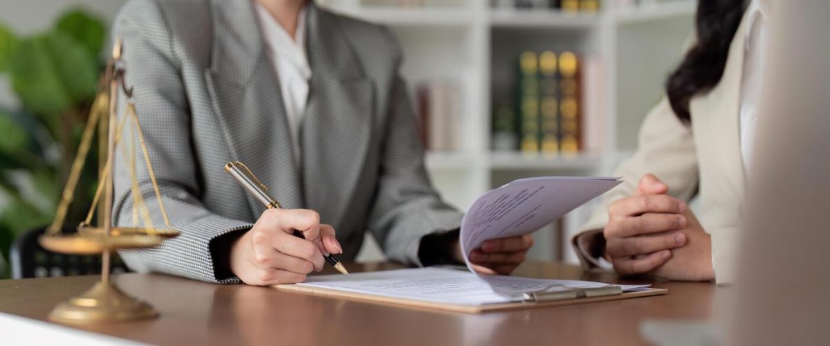 female-lawyers-reviewing-and-signing-legal-documents-photo